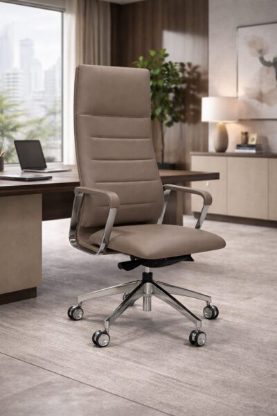 Taupe leather executive office chair with chrome base, shown in a modern executive office with wooden desk and city view