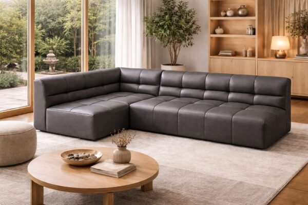 DRUCO modular sectional sofa in charcoal leather featuring high-density foam seating in a modern residential interior.