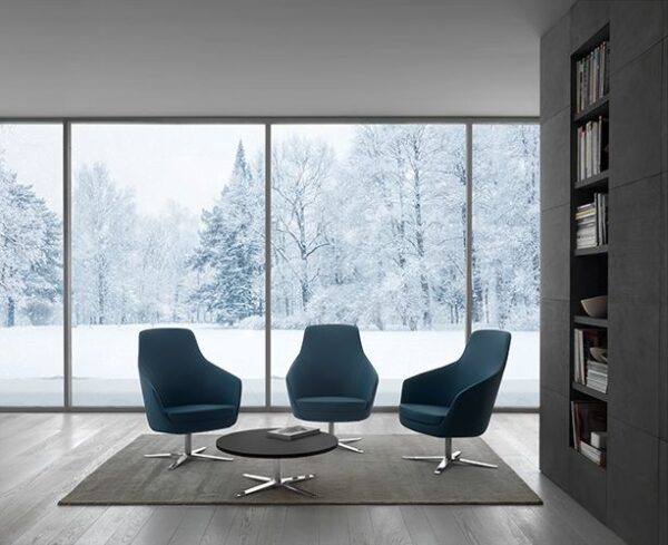 NORA MEDIUM lounge chairs in a modern seating area with round coffee table
