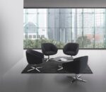 BREK black reception lounge chairs arranged around a coffee table in a modern office